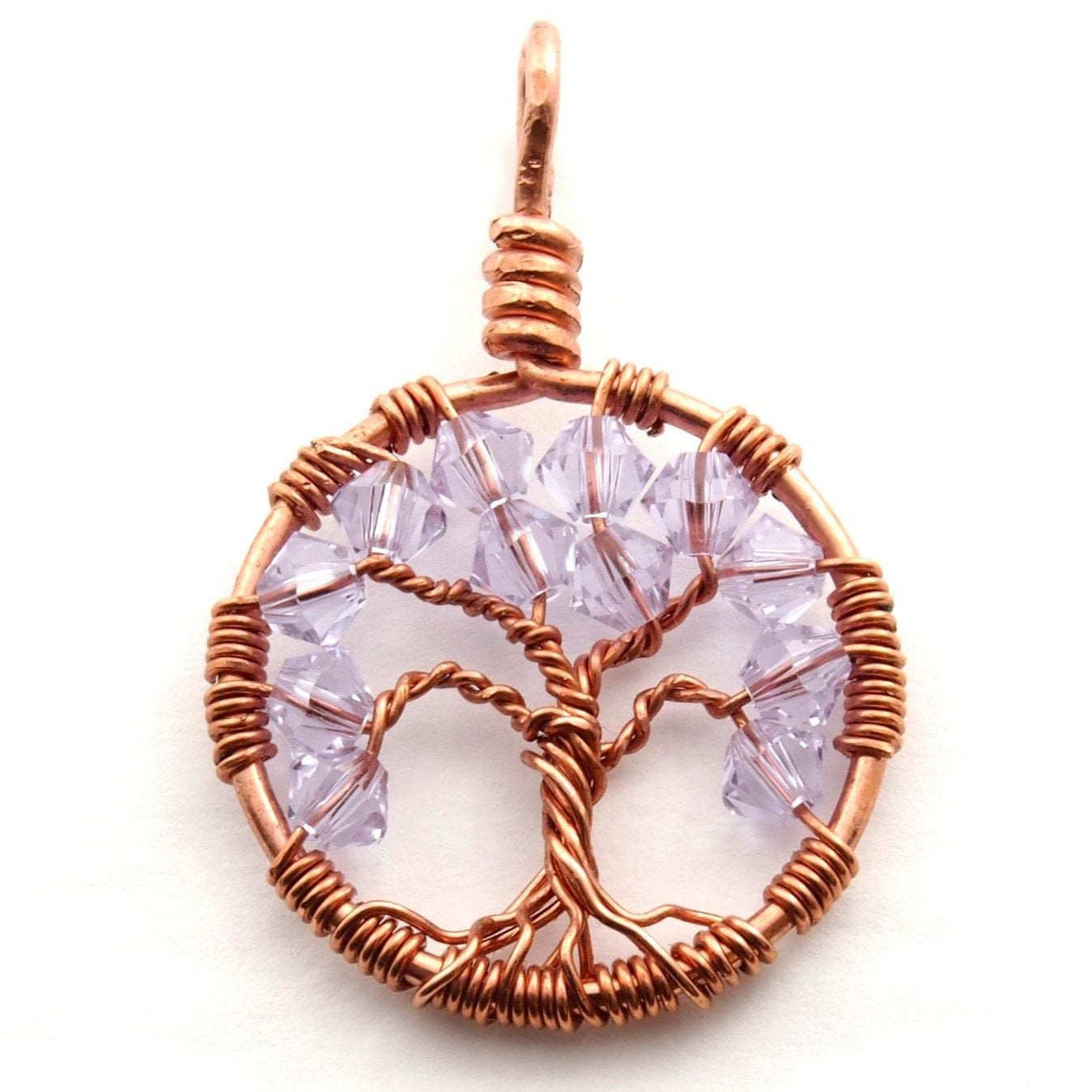 A close up image of the June birthstone tree of life pendant from Uncorked & Bottled Up made with Alexandrite Swarovski crystals and copper wire