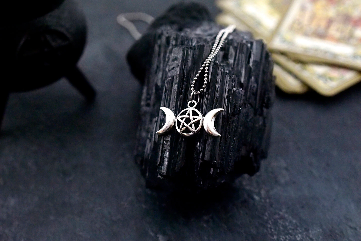 A styled image of the triple goddess pentagram necklace from Uncorked & Bottled Up